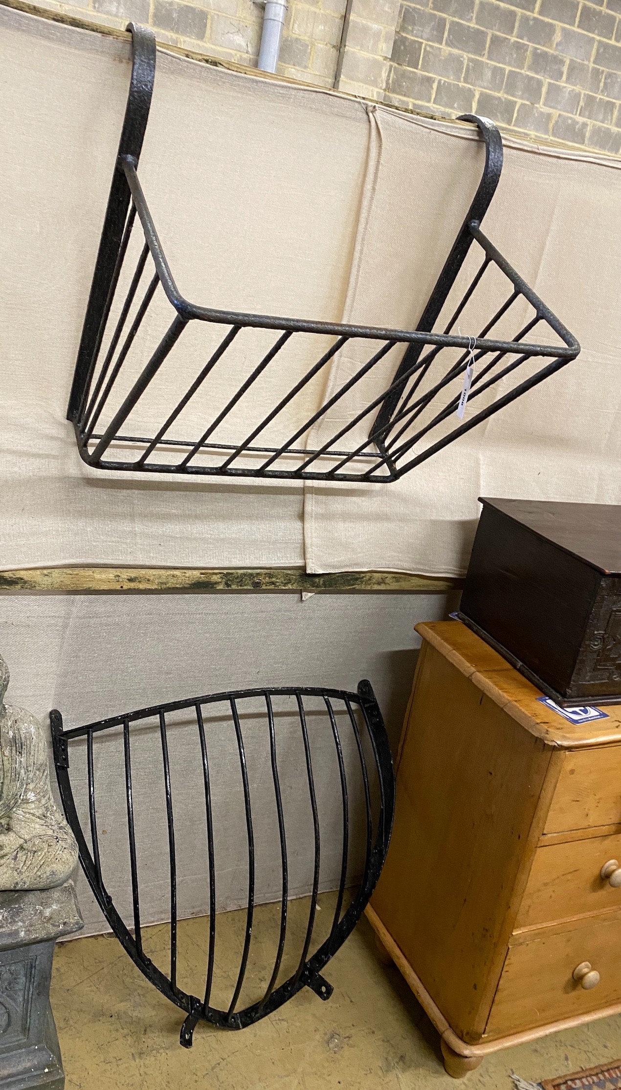 Two wrought iron stable mangers, larger width 64cm